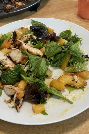 BBQ chicken salad with peaches and greens.