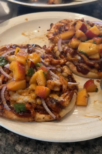 BBQ chicken flatbreads on a wooden serving board
