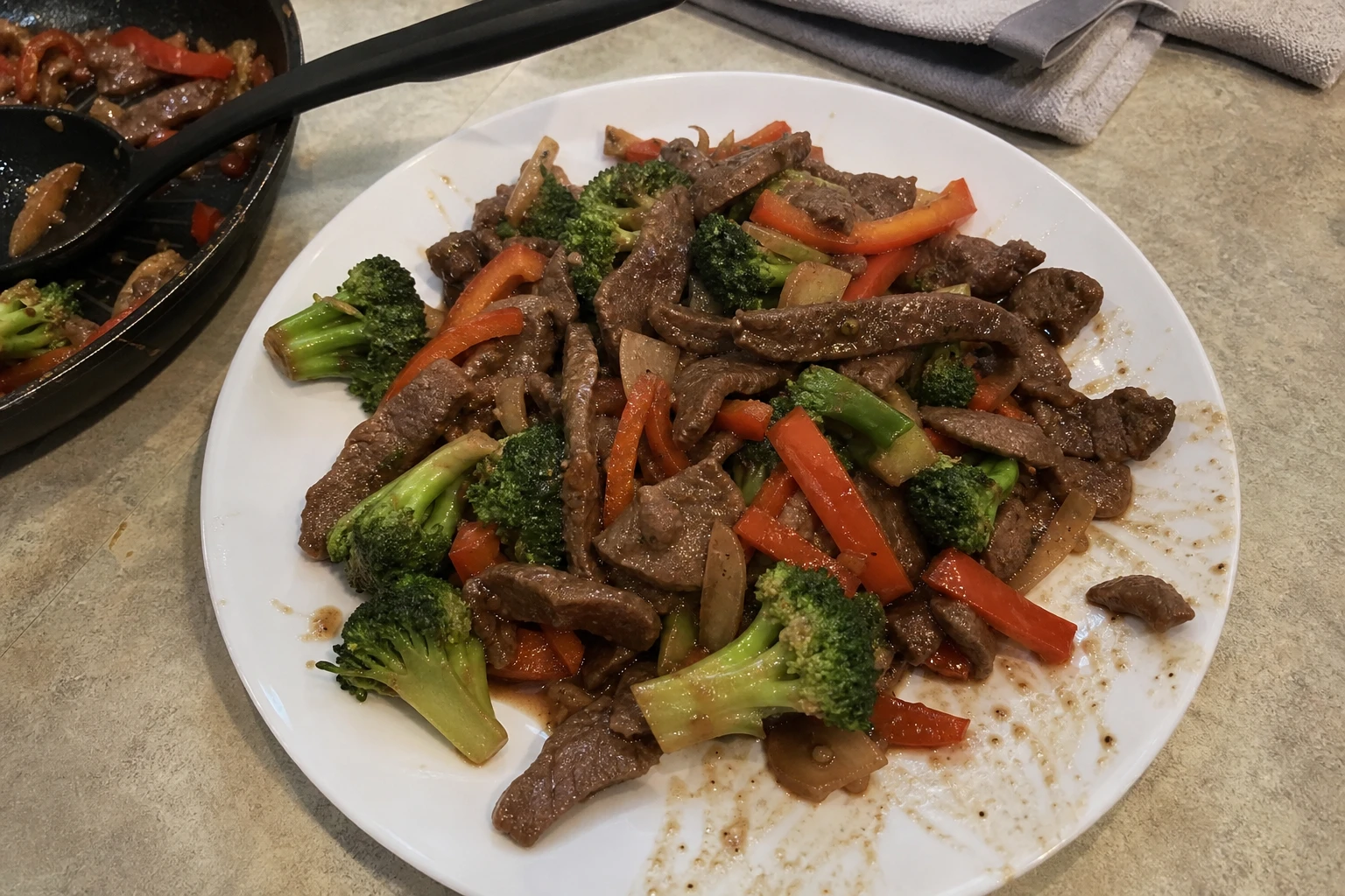 Close-up of stir-fried beef and vegetables glistening with sauce