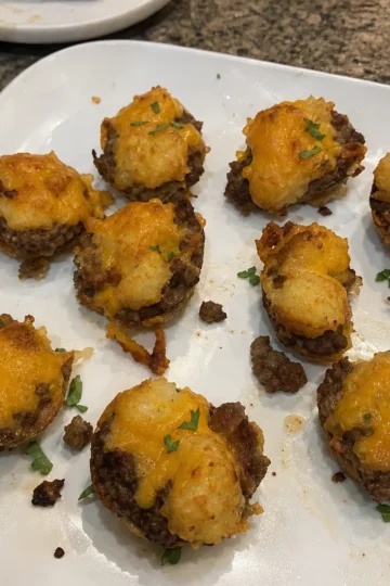 Crispy Beef Tater Tot Bites on a white plate garnished with cilantro
