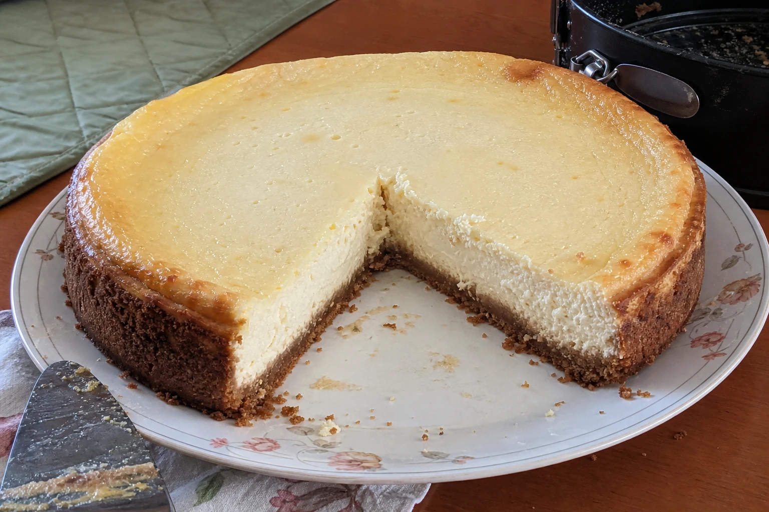 Whole cheesecake on a white platter with fresh berries