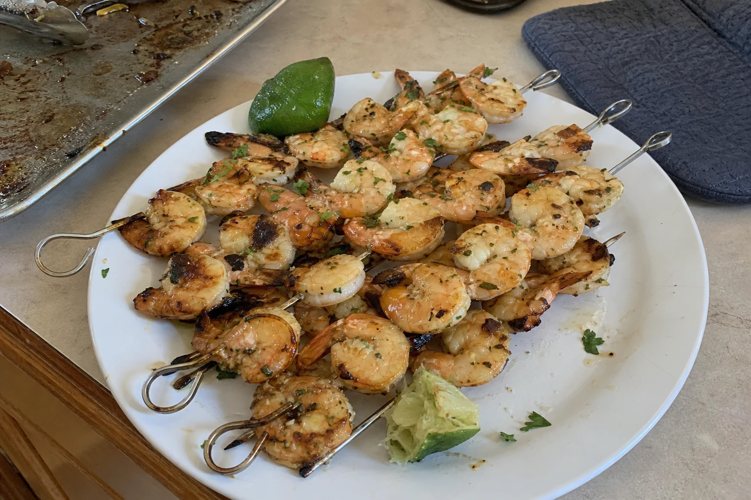 Close-up of coconut lime shrimp skewers with a tropical backdrop