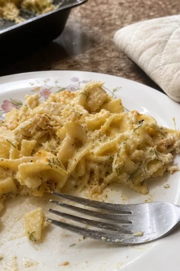 A creamy Fresh Dill and Egg Noodle Bake served in a rustic dish.