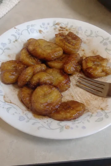 Fried Cinnamon Bananas on a plate with a scoop of ice cream