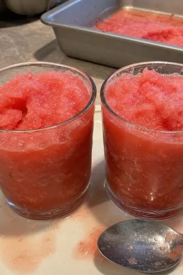 Bright pink watermelon slushies garnished with mint leaves