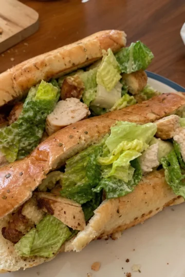 Delicious garlic bread chicken caesar salad sub wrapped in parchment