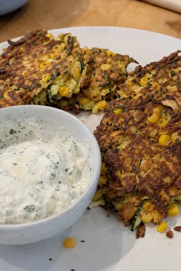 Golden brown grilled zucchini fritters on a plate