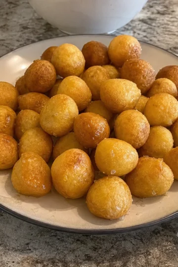 A tray of golden honey butter cornbread poppers fresh out of the oven.