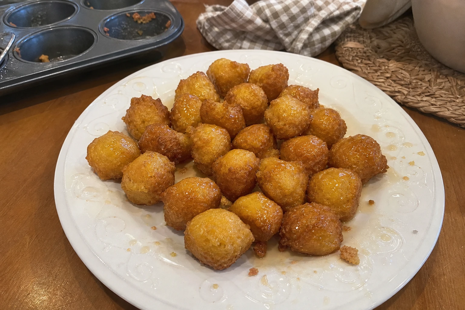 Close-up of honey butter drizzled on cornbread poppers.