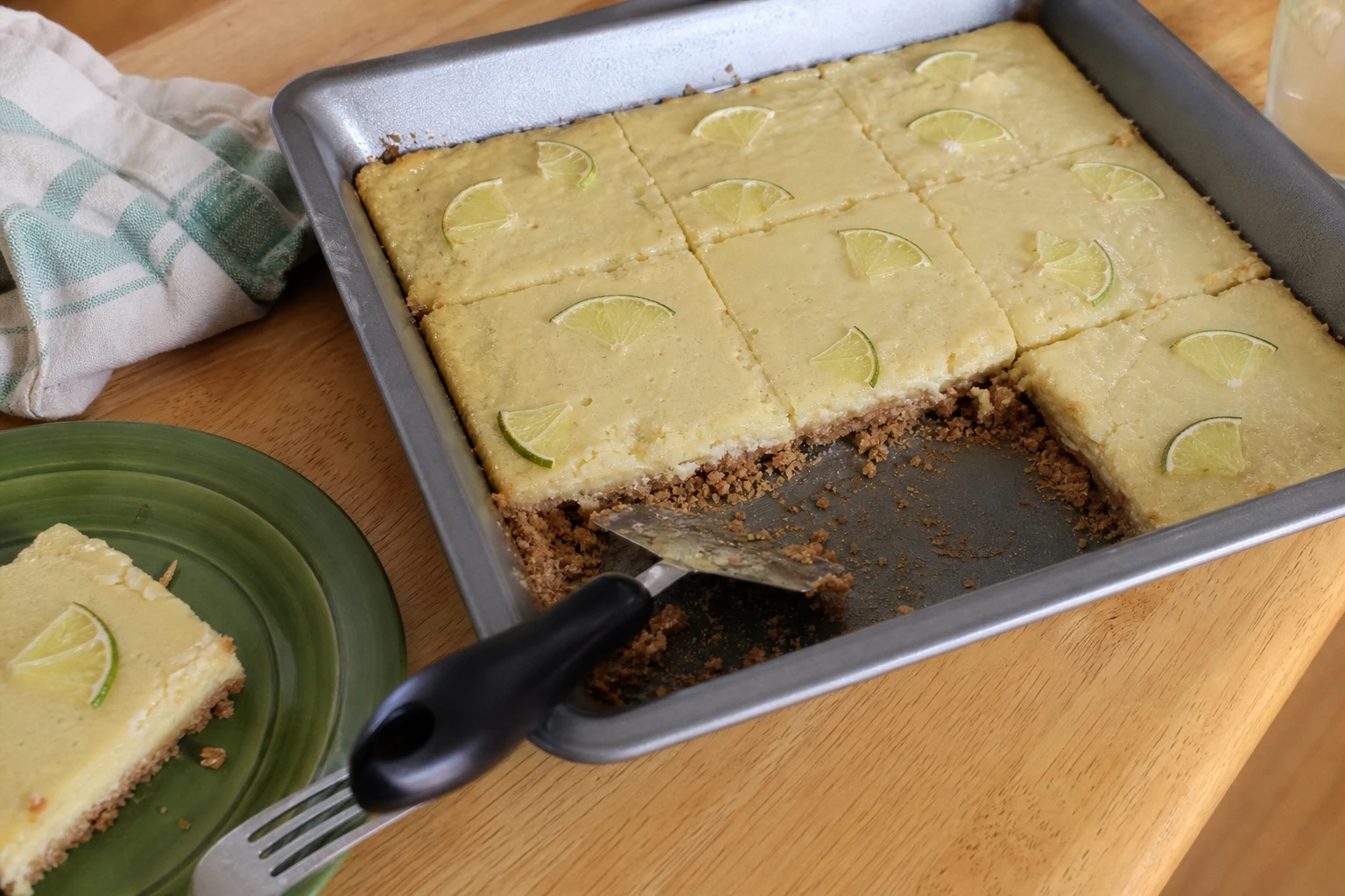 Freshly cut key lime pie bars topped with whipped cream