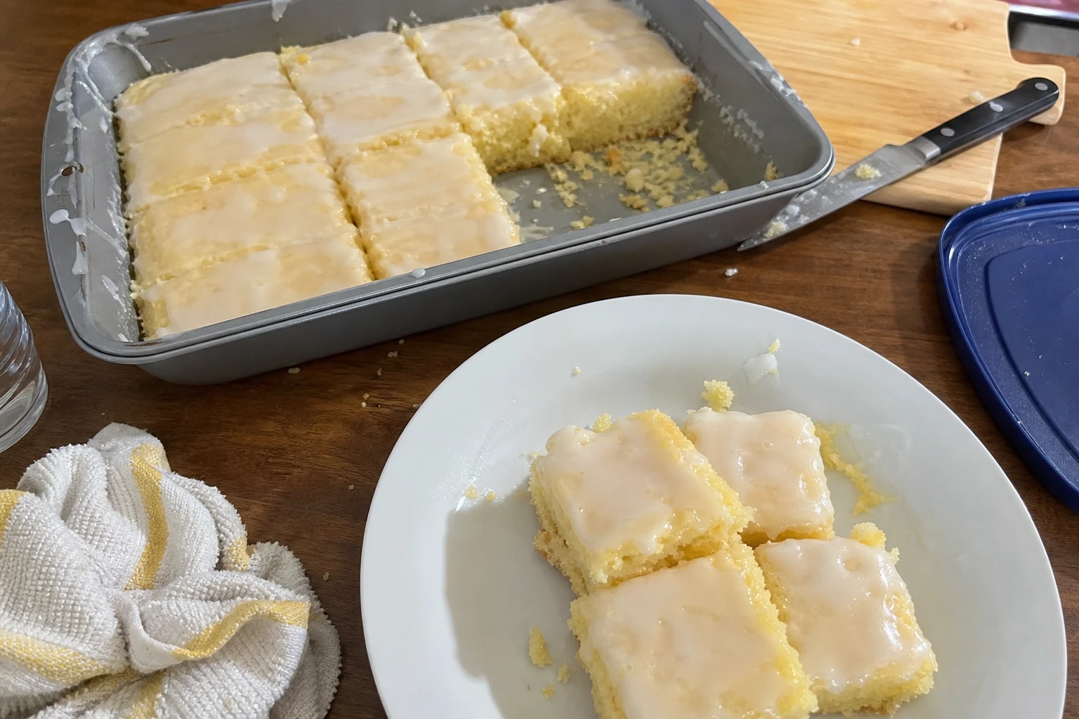 Close-up of a lemon cake bar with a drizzle of lemon icing on top.