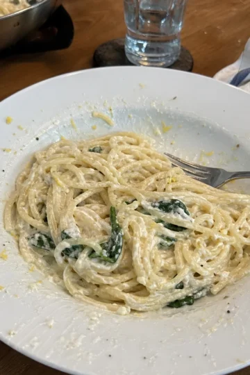 A beautiful bowl of Lemon Ricotta Pasta garnished with fresh basil.