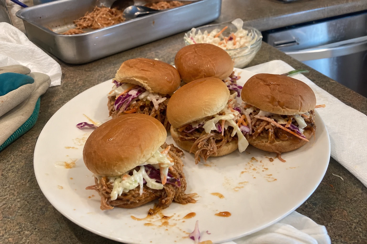 Close-up of BBQ pulled pork spilling out of a slider bun