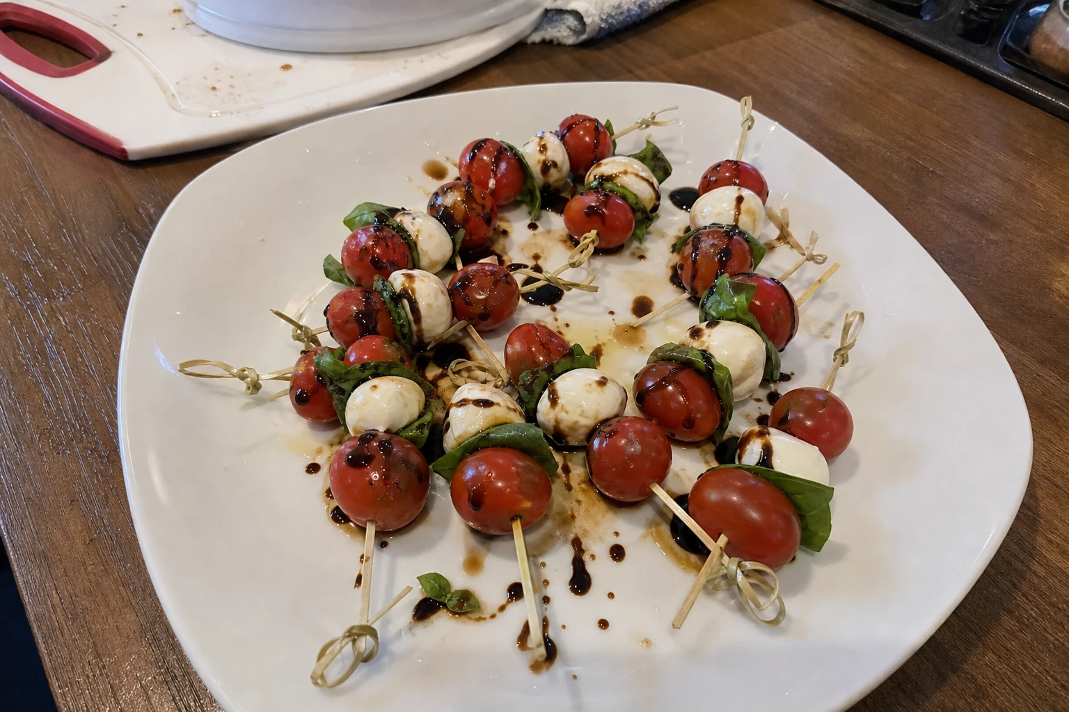 Close-up of mini caprese skewers drizzled with balsamic glaze