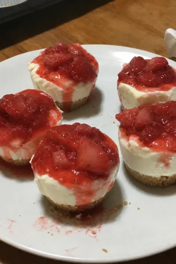 Delicious no-bake strawberry cheesecake cups topped with fresh strawberries