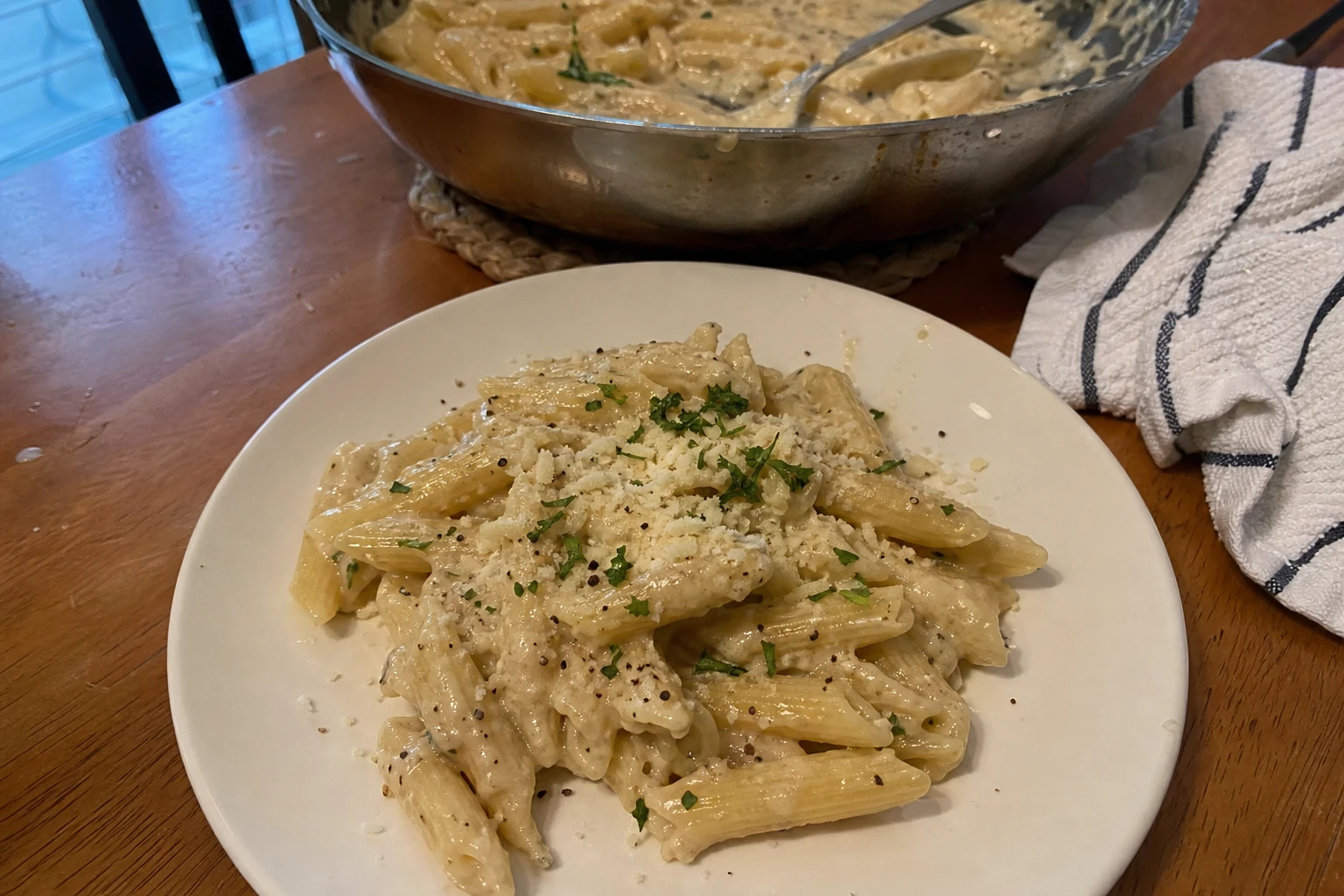 Close-up of creamy garlic pasta with grated parmesan