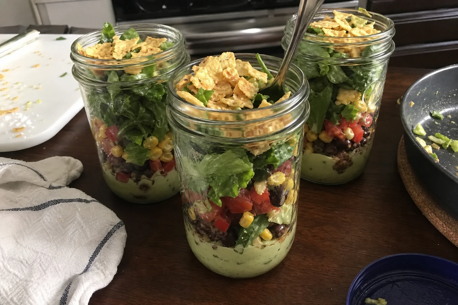 Layered taco salad with avocado dressing in mason jar