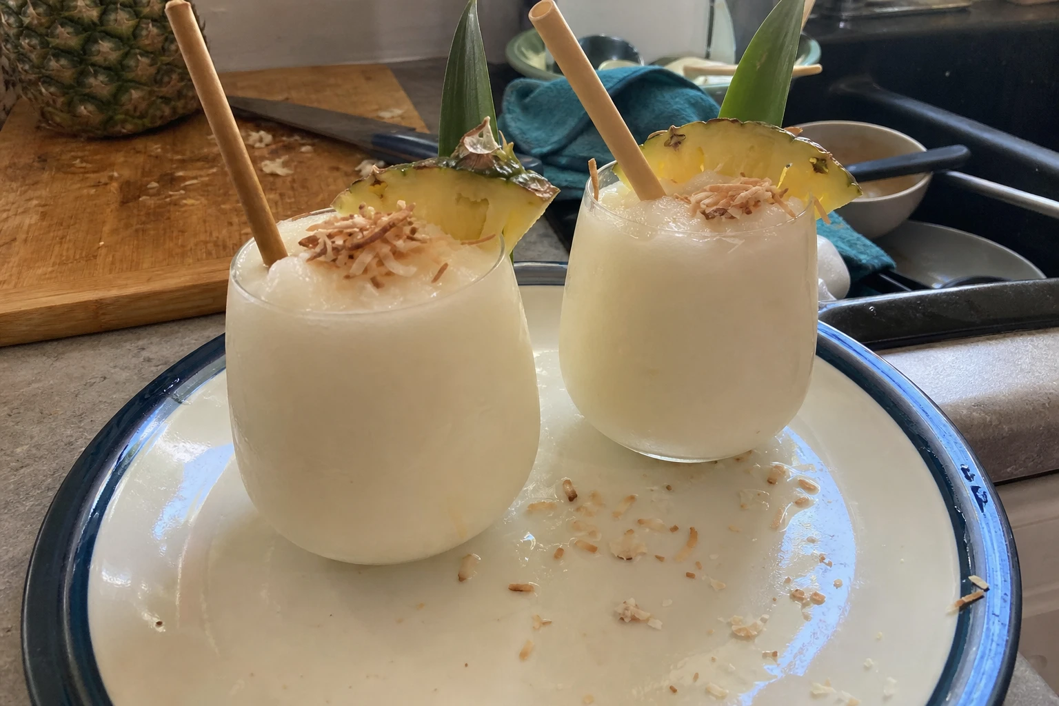 A blender filled with colorful coconut rum slushie ingredients.