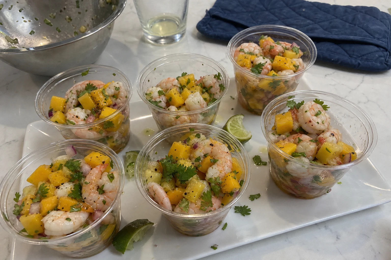 Fresh ingredients for mango shrimp ceviche laid out on a table