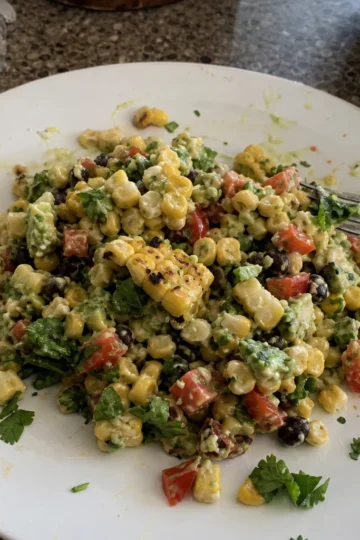 Colorful grilled corn salad with vibrant vegetables and creamy dressing