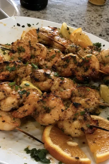 Grilled shrimp skewers on the BBQ with colorful vegetables