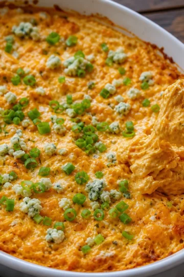 Bubbly buffalo chicken dip topped with green onions