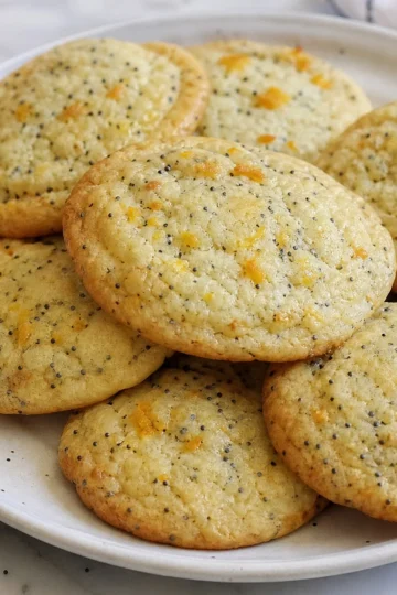 Freshly baked orange poppy seed cookies on a plate