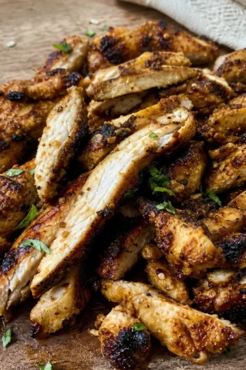 Golden brown oven-roasted chicken shawarma on a platter