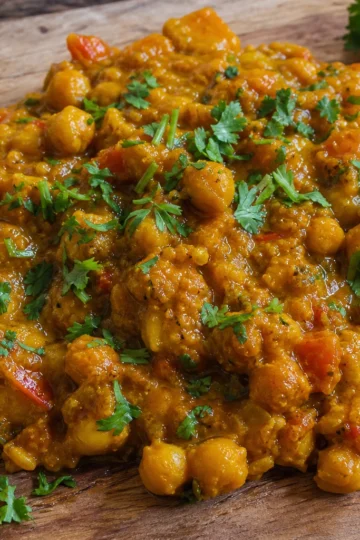 A warm bowl of spiced chickpea stew topped with fresh cilantro